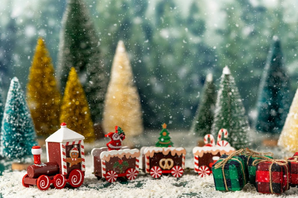 Charming Christmas display featuring a toy train, festive trees, and snowflakes.
