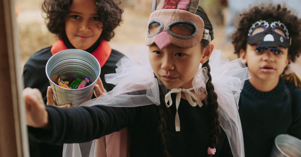 Kids in costumes collecting candy during Halloween trick or treat night.