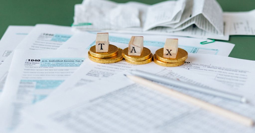 Close-up of tax forms, receipts, and coins symbolizing financial accounting and taxes.
