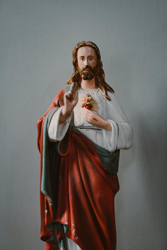 Close-up of a Sacred Heart of Jesus statue indoors symbolizing faith and spirituality.