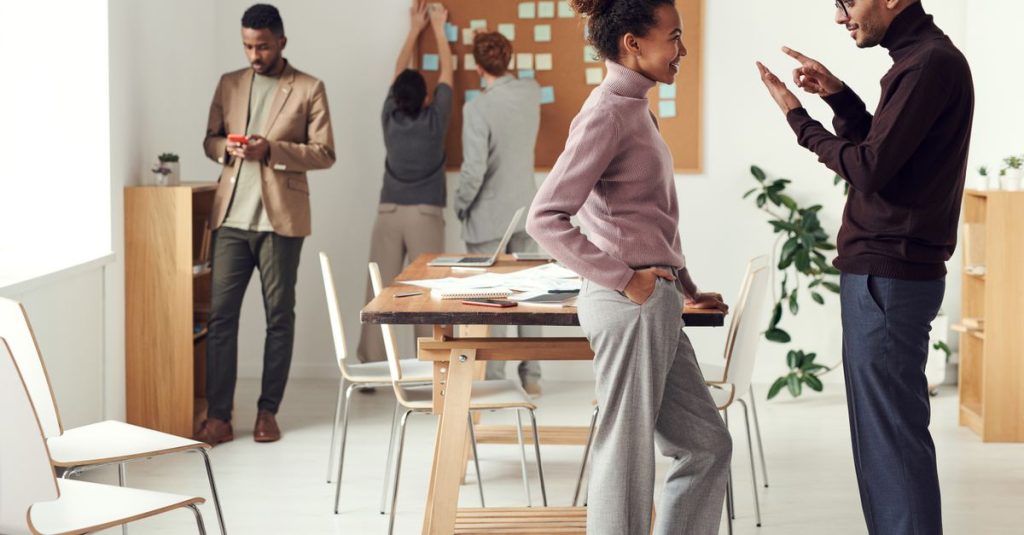 Colleagues engaging in teamwork and brainstorming in a modern office space.