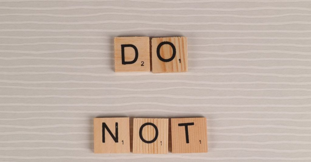 Scrabble tiles arranged as 'Do Not Copy' on a neutral background, conveying originality message.
