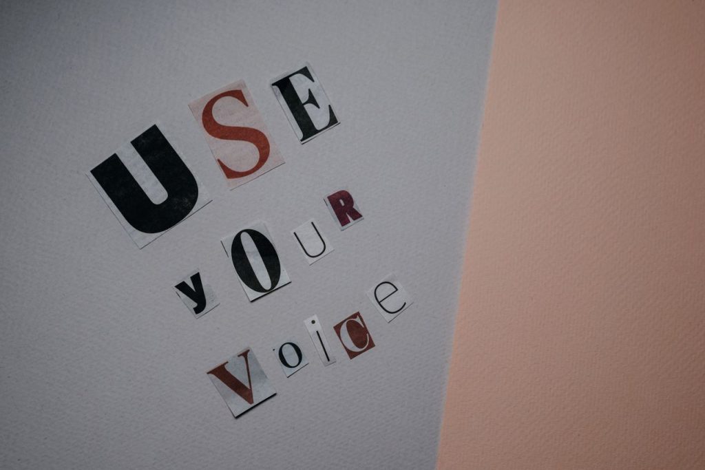 Creative typography reading 'Use Your Voice' on paper, inspiring personal expression and activism.